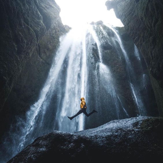 man jumping waterfall
